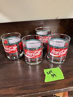Front view of four Coca-Cola tumblers on shelf