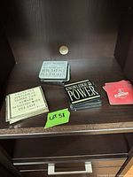 Stacks of mixed quote and beer-brand coasters on shelf