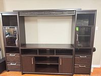 Front view of full wall unit showing shelves, drawers, cabinets