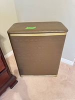 Front view of brown woodgrain vinyl hamper with gold trim