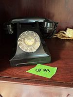 Front view showing rotary dial, handset resting on cradle