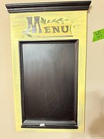 full view of wall-mounted yellow frame chalkboard menu board