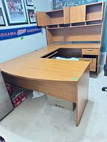 Full view of U-shaped desk with attached hutch, drawers and keyboard tray