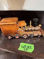 Left side view of wooden steam locomotive model