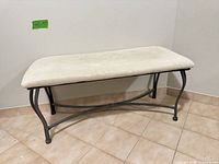 Full view of bench showing metal frame and upholstered seat