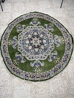 Full view of round green rug showing overall design and size