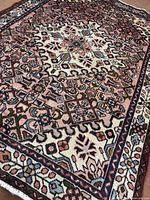 Angled view showing overall pattern and colours of the rug