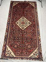 Full view of Hosseinabad rug showing entire design and borders