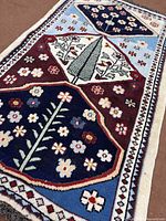 Full view of Shiraz rug showing design and fringe