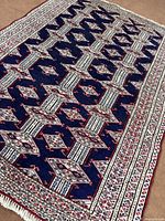 Full angled view of Torkaman rug showing entire pattern and fringe