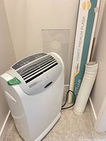 Full view of portable air conditioner with hose and window panel