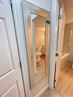 Full view of wall-mounted silver-tone framed mirror