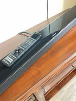 Top view of Bose soundbar with remote on wooden surface