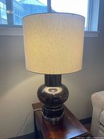 Lamp fully assembled with shade lit