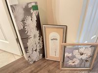 All three art pieces standing against wall