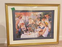 Front view of framed Renoir print with gold frame and mats