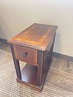 Three-quarter view of entire side table showing drawer and shelf