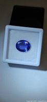 Oval deep blue tanzanite in display box
