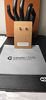 Stud earrings on card marked "Untreated Aquamarine" with CRWN GEMS folder beneath