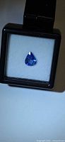 Pear cut blue sapphire in display case
