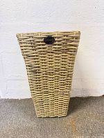 Front view of light brown tapered square polyrattan planter