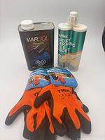 Group shot showing Varsol can, Perflex grout cartridge, and two pairs gloves