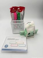 Complete set showing pen holder containing highlighters, edge punch and label set nearby