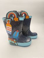 Pair of navy George children’s rain boots with rocket and rainbow appliqués