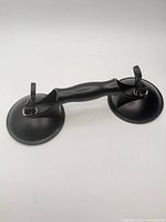 Full view of double suction lifter showing handle and both suction cups