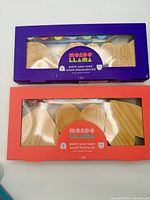 Front view of two boxed Mondo Llama paint kits