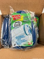 Box containing multiple sealed Scotch-Brite no-scratch scrubber refills