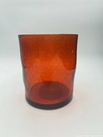 Front view of amber bubbled glass hurricane candle holder showing color and texture