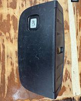 Front view of black panel showing hood release button