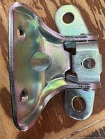 Front view of zinc-plated upper door hinge showing three mounting holes