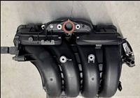 Top view of Toyota Corolla intake manifold showing throttle body opening and sensor ports