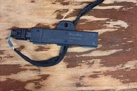 Aerial antenna with wiring harness on wood surface showing connector and housing