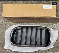 Grille on protective wrap with original box and BMW label visible