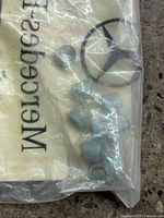 sealed Mercedes-Benz bag showing several light blue clips