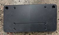 Front view of black plastic license plate holder showing mounting holes