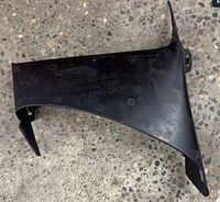 Overall view of black plastic trim cover showing shape and mounting points