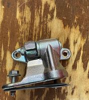 Hinge side view showing mounting plate and bolt