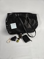 Coach black leather tote with accessories grouped
