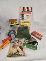 Group shot showing locomotive, four cars, transformer, scenic hill, station, tunnel portal, booklet, scenic material box