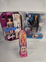 Group shot of all three boxed Barbie dolls
