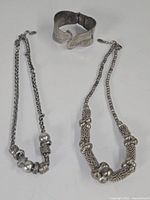 Entire lot showing cuff and two necklaces