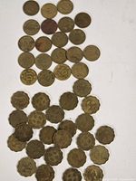 Overview of mixed Hong Kong 10¢ and scalloped 20¢ coins spread on white background