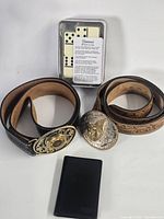 Group shot of both belts, card wallet and domino tin