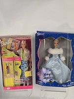 Front view of both boxed Barbie dolls