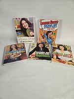 Five Rachael Ray paperback cookbooks front covers displayed