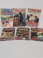 Group shot of all six comic books laid out